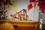 LEGO cabin displayed on dresser.