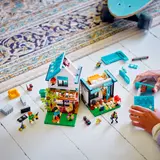 Child building LEGO Cozy House.