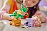 Hands assembling LEGO Cozy Plants.
