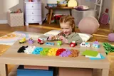 Child playing with LEGO Classic bricks and models.