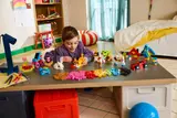 Happy child building LEGO.