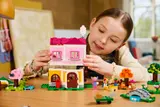 Child playing, stacking houses.