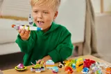 Boy holding custom LEGO spaceship.