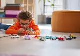 Child building a LEGO car.