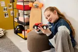 Girl holding car.