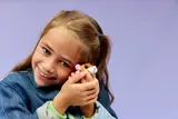 Girl holding LEGO hamster.