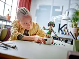 Child building LEGO Dancing Groot.