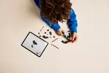 Child building mech with tablet