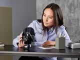 Person examining Vader helmet.
