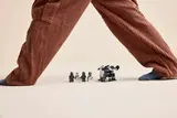 Minifigures and transport under giant legs.