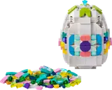 White LEGO Easter egg with colorful patterns, loose bricks.