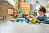 Child playing with Duplo Spidey-Rex.