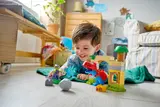 Child smiling during Duplo play.