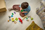 Duplo pieces scattered on floor.