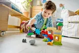 Child focused on Duplo play.
