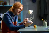 Person adjusting LEGO Luxo Jr. lamp.