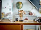 LEGO Dobby waving on a desk.
