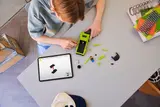 Boy building LEGO Hellcat with digital instructions.