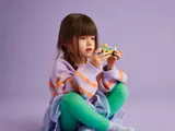 Child holding LEGO Friends Dog-Grooming Car.