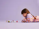 Child playing with LEGO Friends Dog-Grooming Car set.
