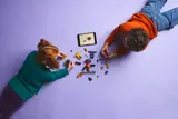 Kids building LEGO Ninjago set from above.
