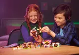 Children building LEGO DREAMZzz modules.