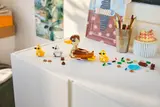 LEGO duck family with scattered bricks.