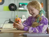 Girl holding Durrr Burger, smiling.