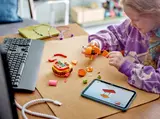 Girl building Durrr Burger with tablet.