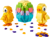 Two yellow LEGO chicks and a colorful Easter egg with scattered tiles.