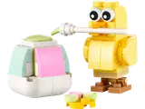 LEGO chick painting a pastel Easter egg.