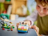 Child pushing LEGO Friends electric car.