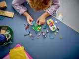 Overhead view of LEGO pieces and child's hands.