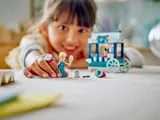 Child holding Elsa and wearing ring.