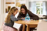 Child and adult playing with LEGO Frozen castle