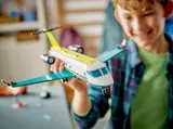 Boy proudly holding LEGO Air Ambulance.
