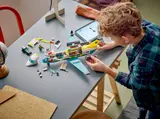 Boy building LEGO Air Ambulance with tablet.