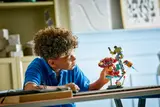 Child admiring the completed LEGO set.