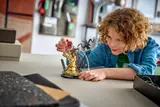 Child posing LEGO Spider-Man on set.