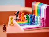 Yellow minifigure stepping onto LEGO rainbow base.