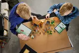 Kids building with tablets.
