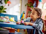 Child playing with parrot.