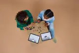 Two people building LEGO® F1 ACADEMY™.