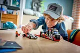 Child playing with LEGO F1 set.
