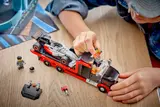 Child loading LEGO F1 car.