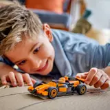 Child playing with F1 car.