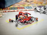 F1 pit stop set in play on marked floor.