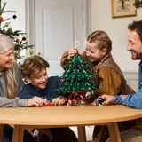 Family building LEGO Christmas tree.