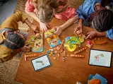 Overhead view of people collaboratively building the LEGO Friends Beach Resort.