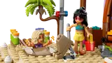 Close-up of LEGO Friends minifigures digging on the beach.